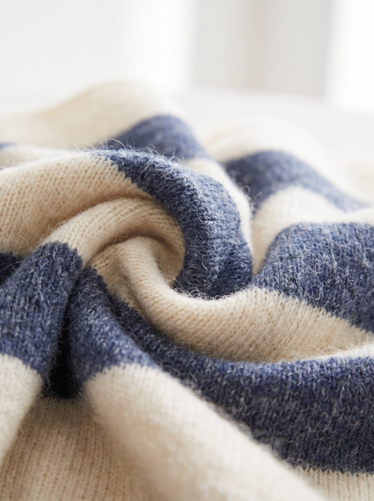 Folds of navy and ivory knitted cloth